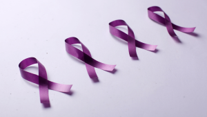 Four purple ribbons are placed on a table.