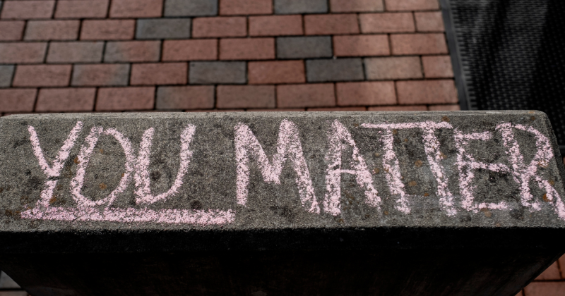"You Matter" is written in pink chalk on a cement.